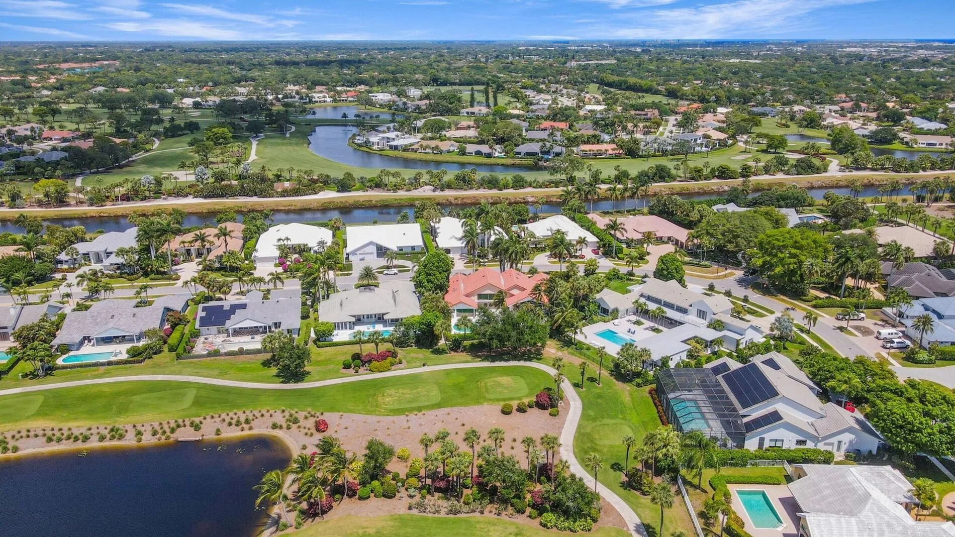 Aerial view of luxury homes with pools along a golf course in Bocaire Country Club, Boca Raton, Florida.
